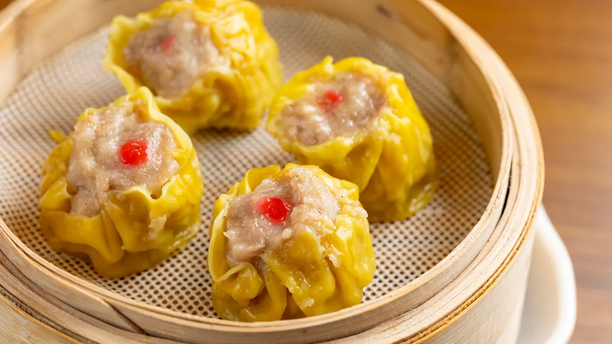 Siu mai dumplings in a bamboo steamer at Dumpling Time Block Place