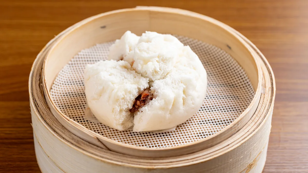 BBQ pork bun in a bamboo steamer at Dumpling Time Block Place