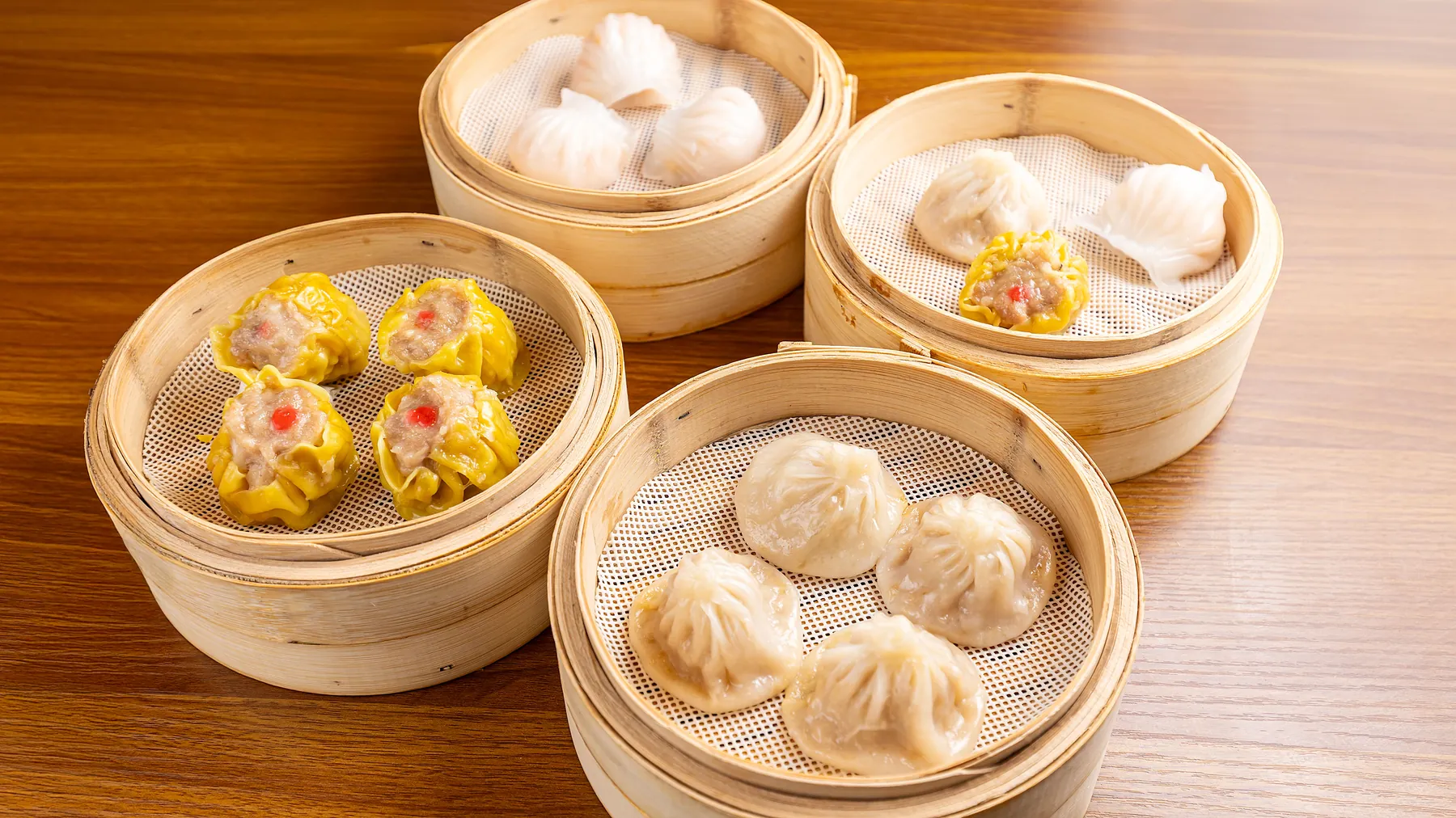 Bamboo steamers of har gow, siu mai and xiao long bao at Dumpling Time Block Place