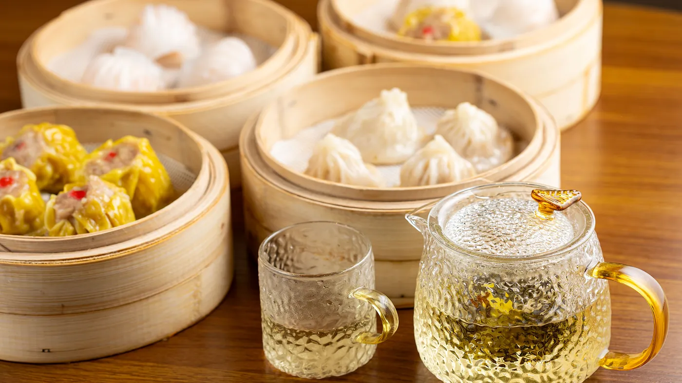 Dim sum steamers with tea at Dumpling Time Block Place
